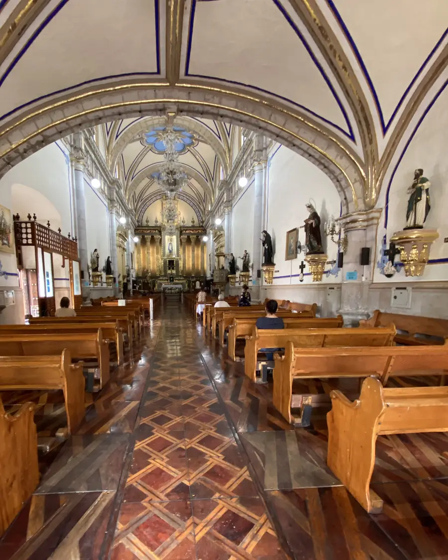 A sanctuary aisle beneath gold-trimmed arches