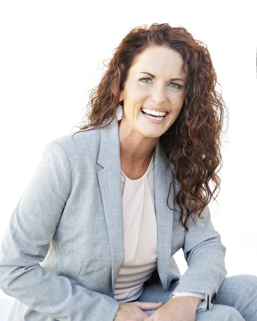 Tanya Waymire, smiling, in a light gray suit