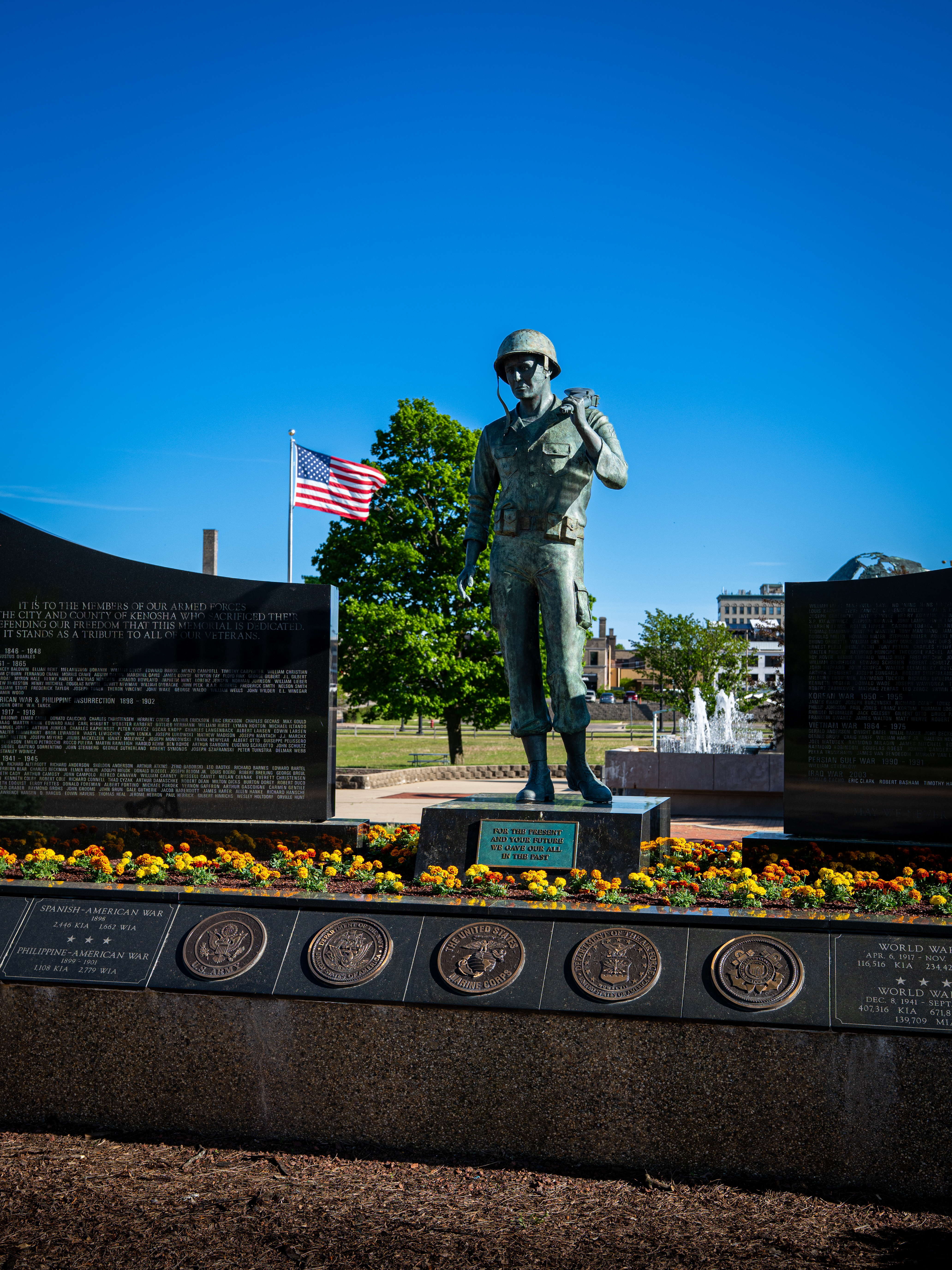 Soldier statue in downtown Kenosha with an American flag in the background