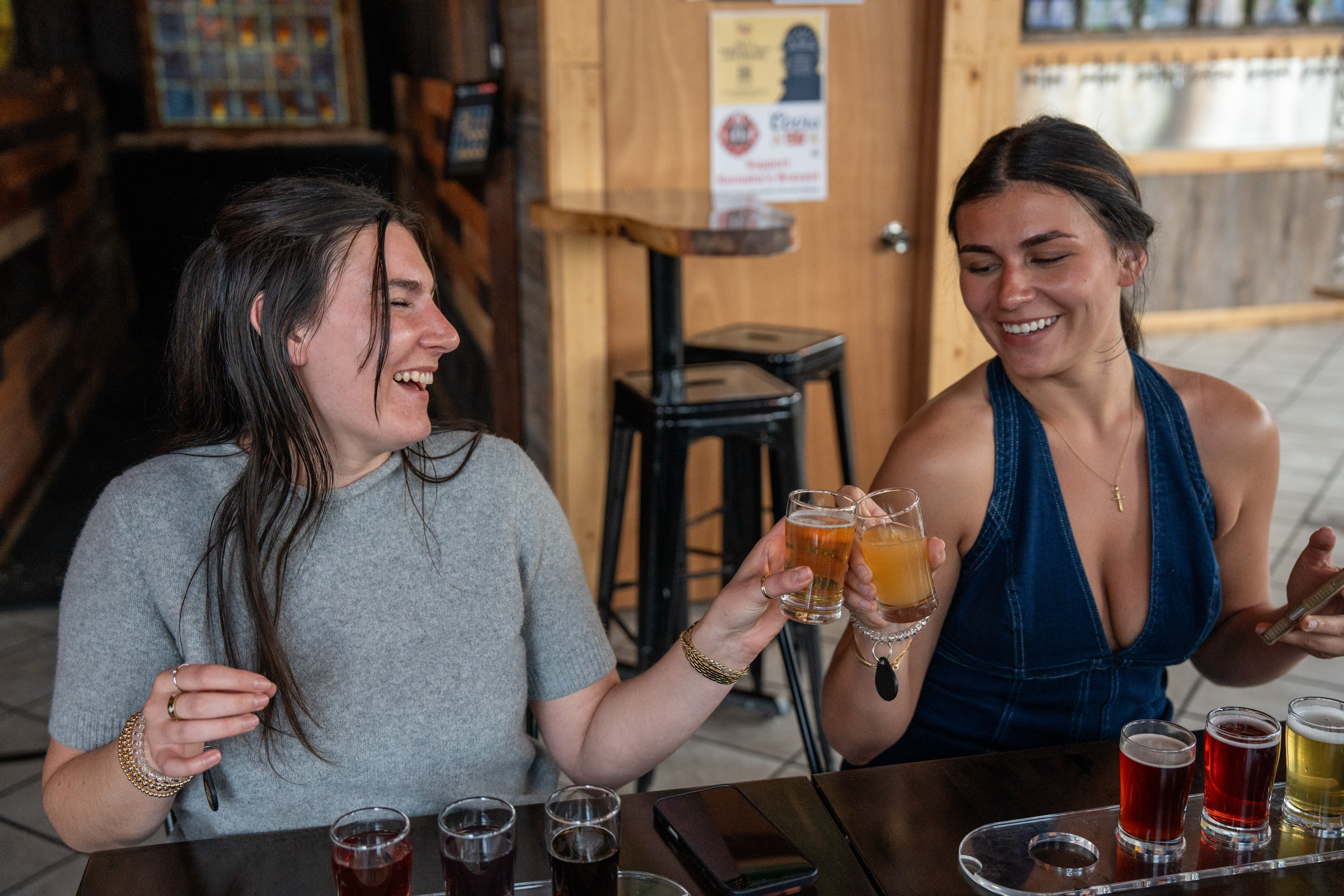 Two guests raising a toast at a local taproom