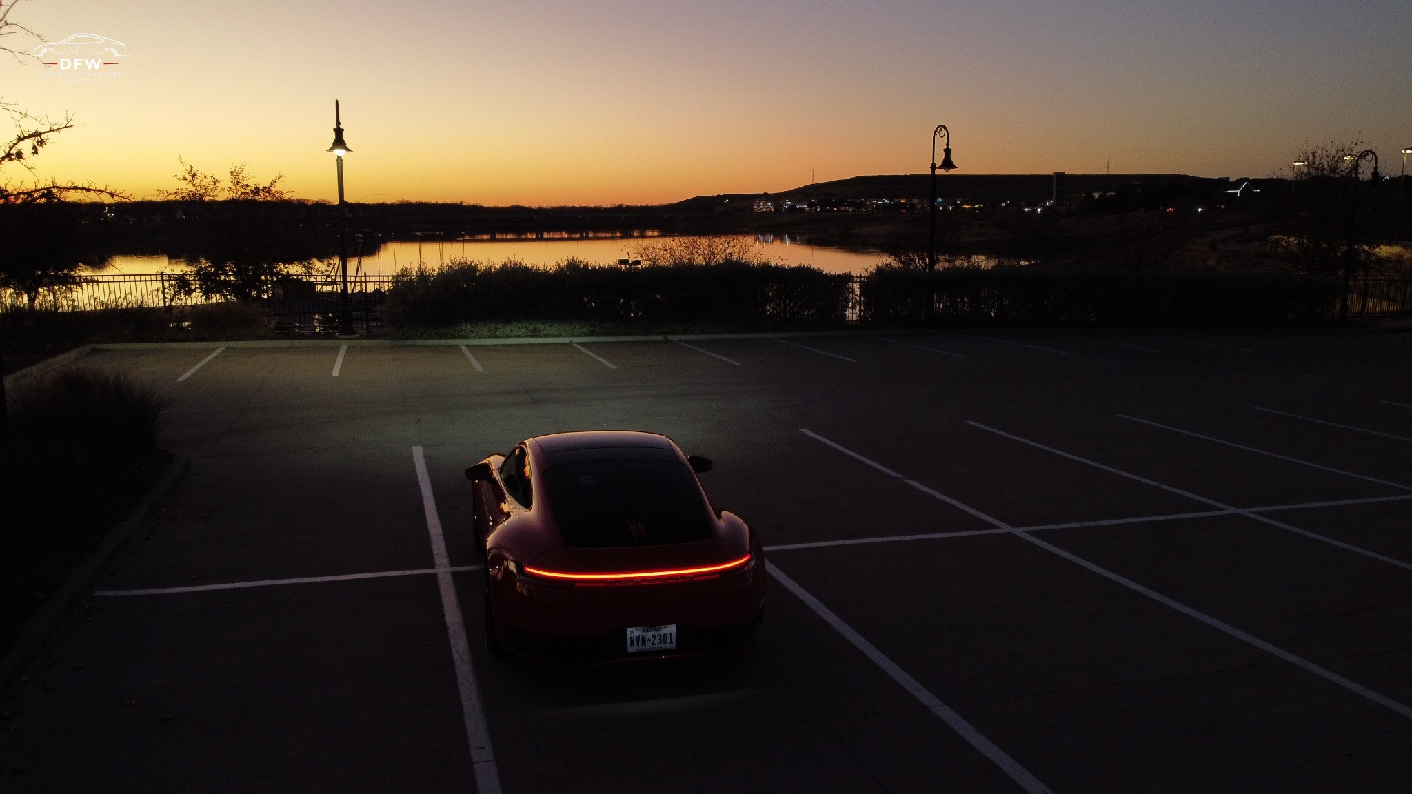 Guards Red Porsche 911 Carrera at dusk in Dallas luxury rental setting Guards Red Porsche 911 Carrera at dusk in Dallas luxury rental setting