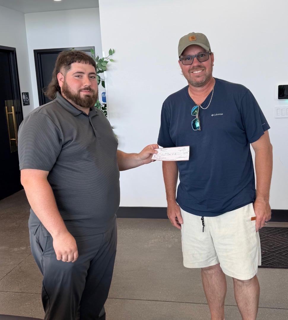 A seller receiving a check for his vehicle at The Auto Lot in Kennewick, WA