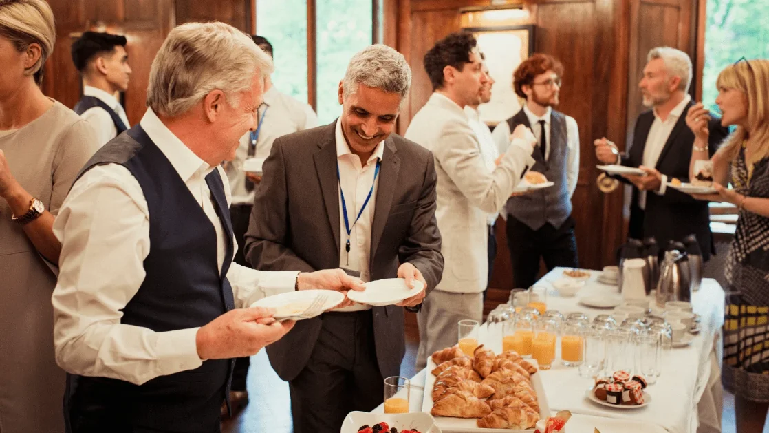 Clinicians talking over breakfast at a networking event