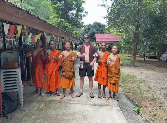 Callum with a group of young monks at a temple in Thailand
