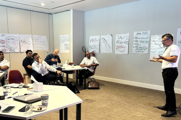 Leadership team working through sales execution alignment during a structured training session.