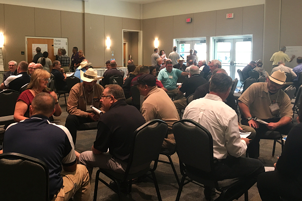 Executive sales leaders participating in a collaborative sales calibration workshop to improve leadership alignment, forecasting consistency, and revenue execution.