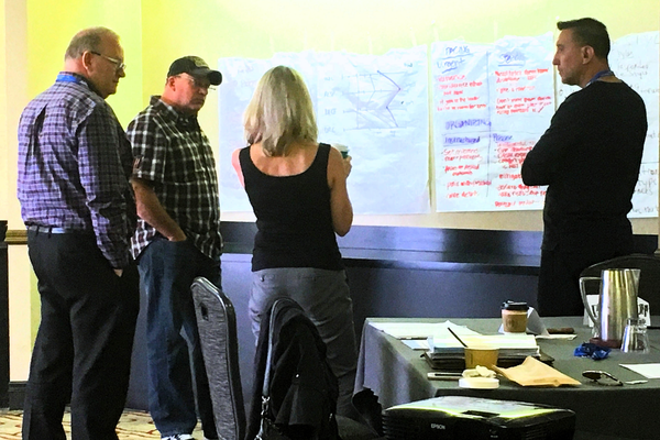 Executive team mapping decision authority, evidence, trade-offs, ownership, and operating commitments during a leadership calibration session.