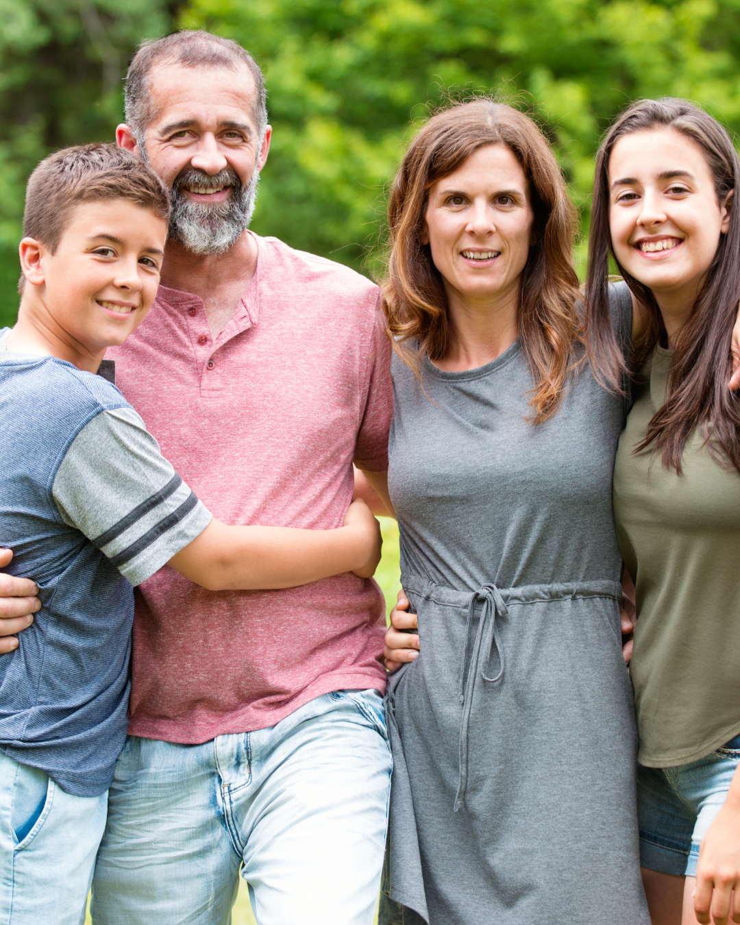 A happy family standing together with their arms around each other