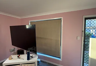 Soft pink bedroom walls with white cornice and window trim after interior house painting in North Booval