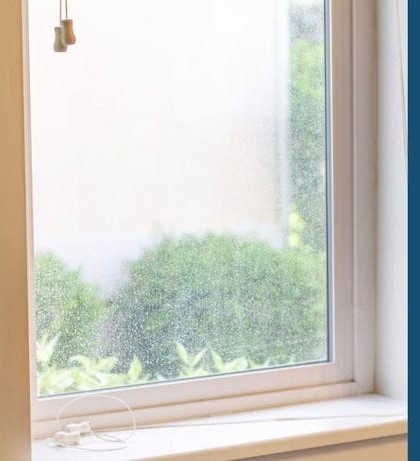 M&M Window Washing before window cleaning showing dirty glass with buildup and reduced visibility