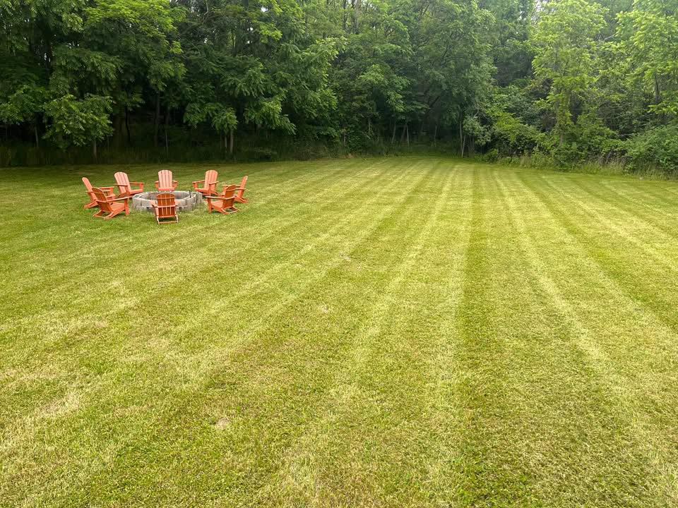 Striped lawn with fire pit and Adirondack chairs, Penn Yan