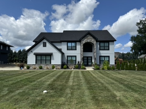 Striped lawn in front of a two-story home