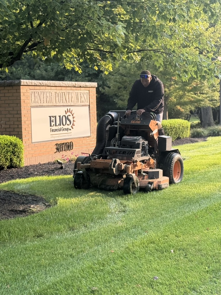 Doskoch crew mowing a commercial property on a ride-on mower