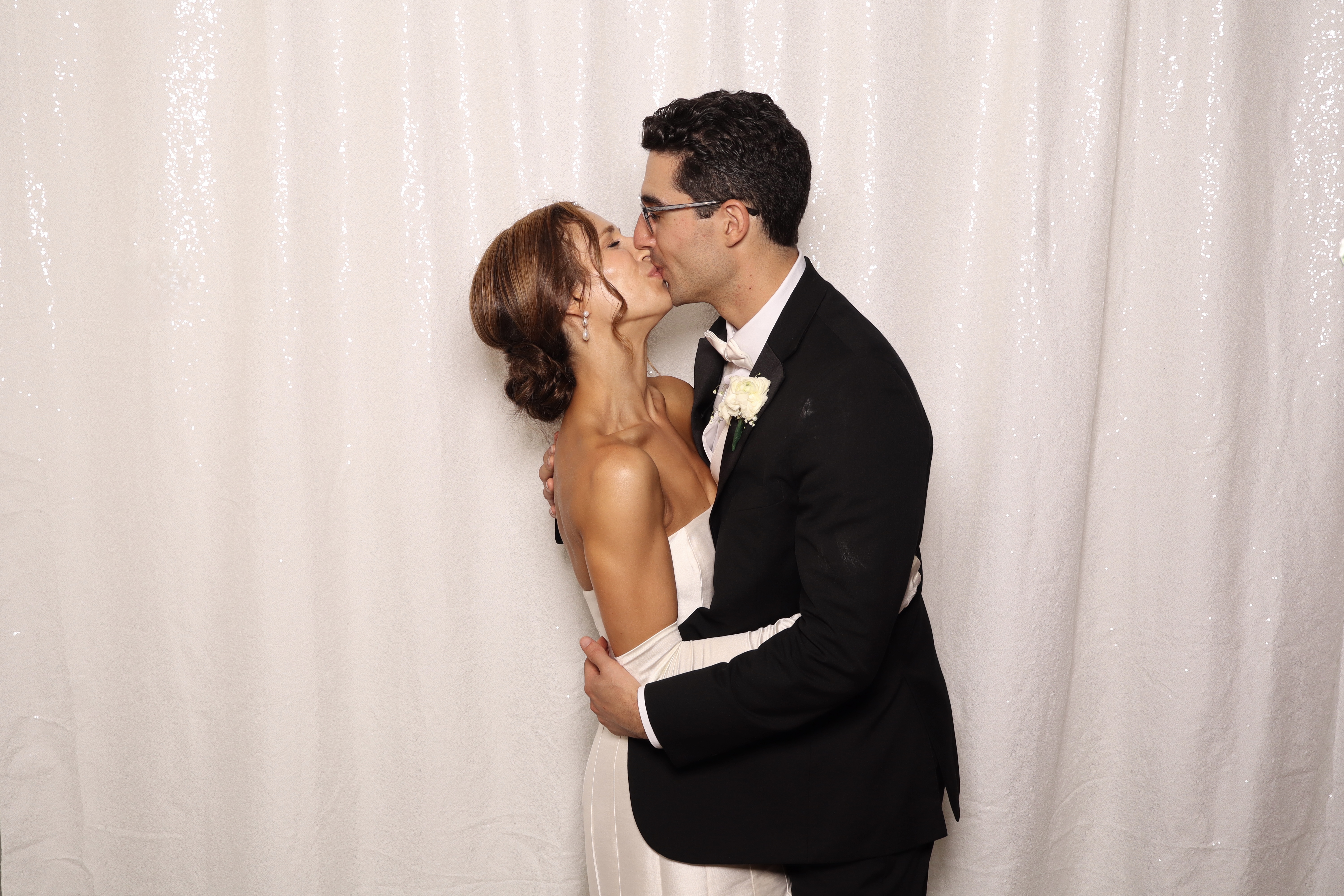Bride and groom kissing at photobooth