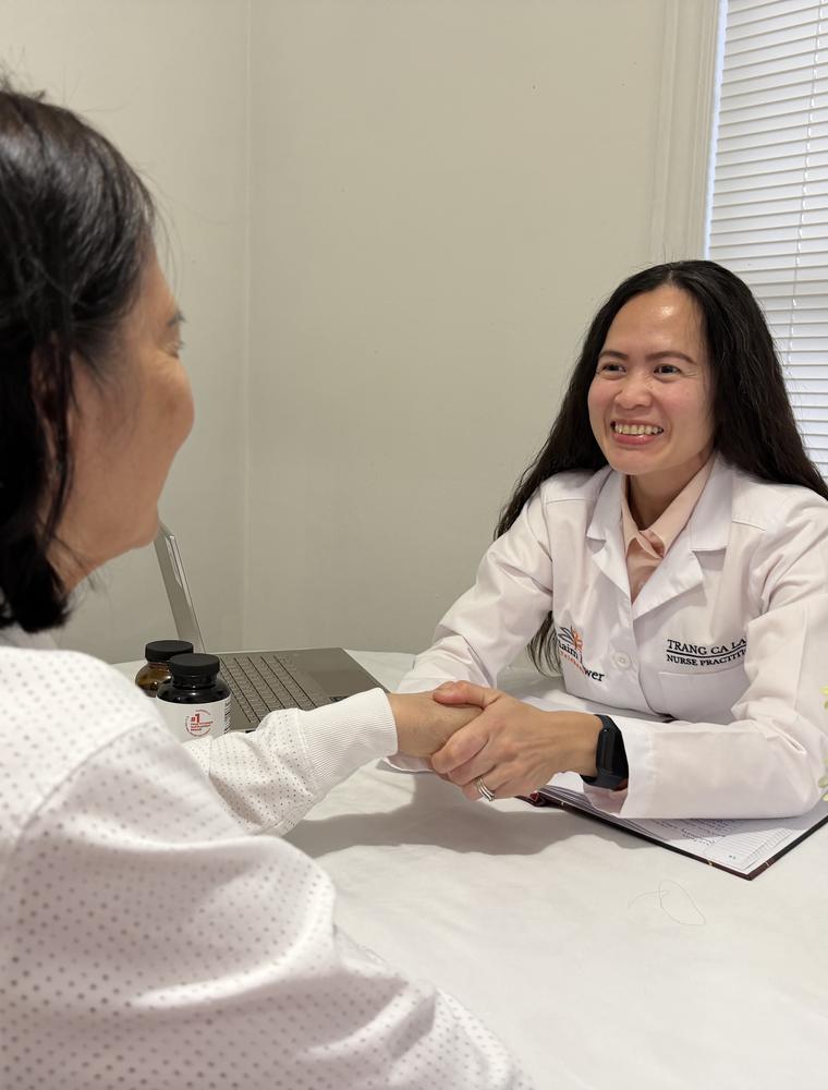Trang meeting with a patient across a table