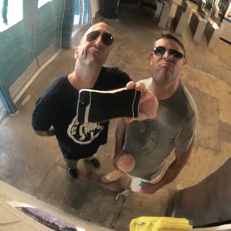 Jon and Chris taking a selfie in a round mirror