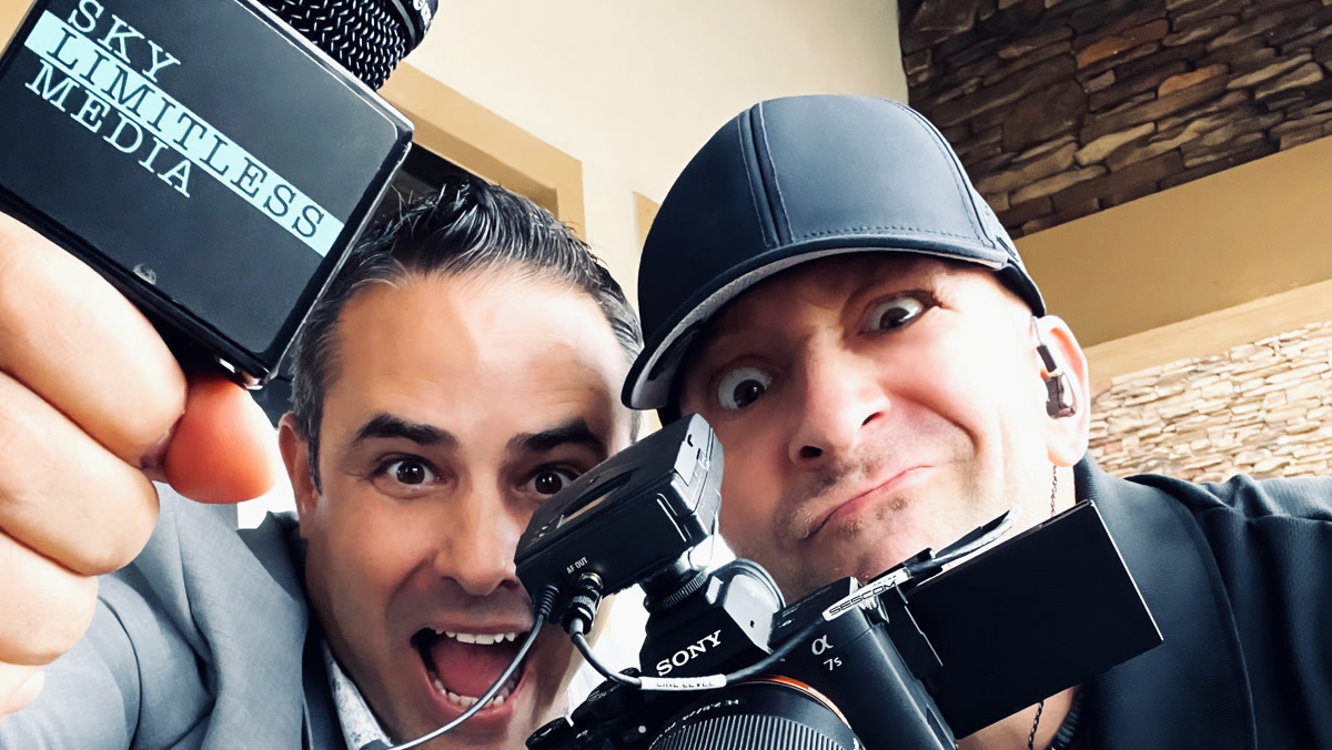 Chris Abazis with a Sky Limitless Media microphone and Jon Manzi behind the camera