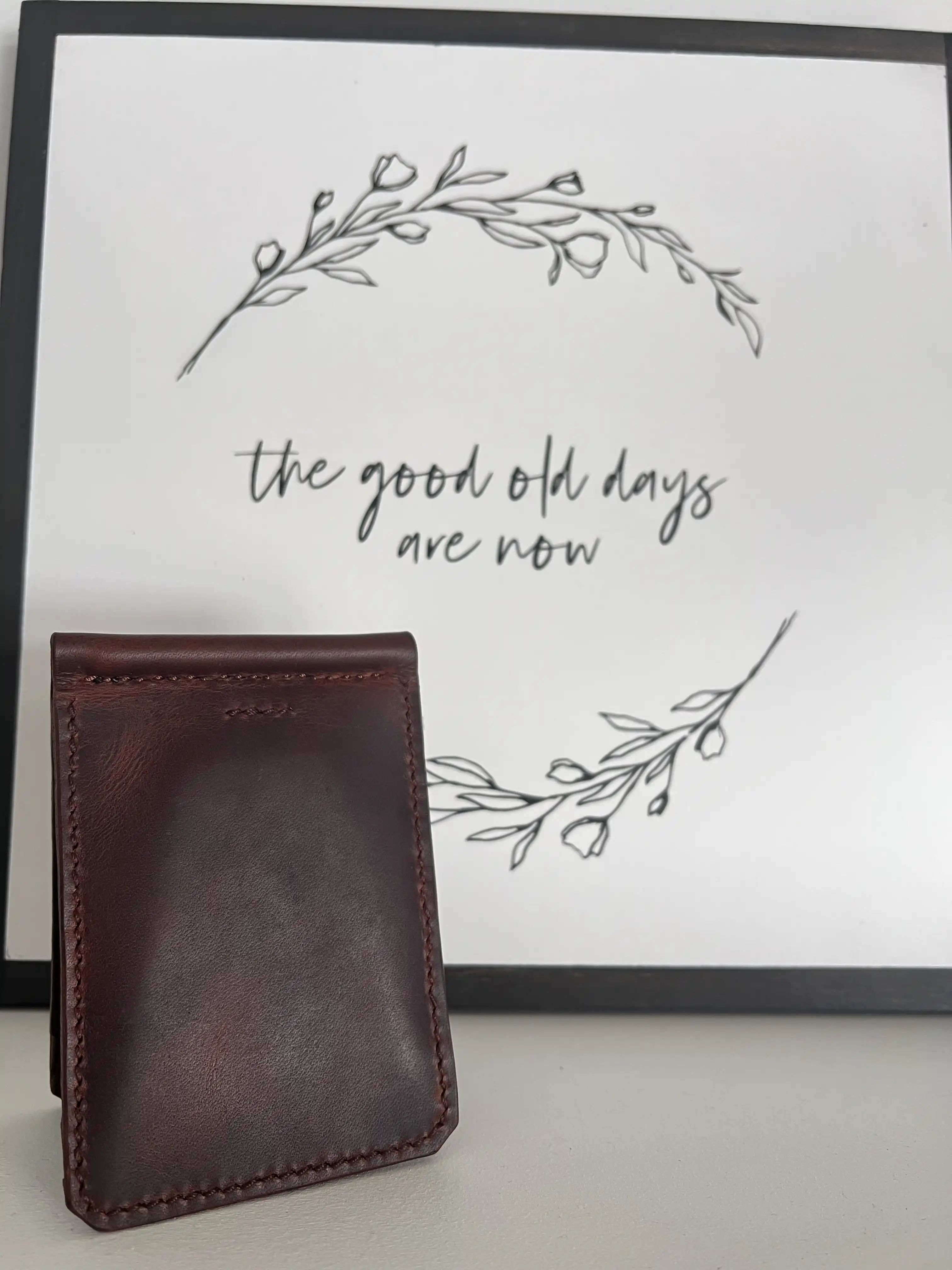 black leather wallet infront of a sign