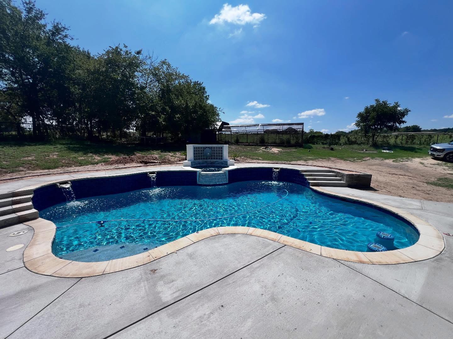 Pool cleaning service in Haslet, TX backyard pool with clear blue water