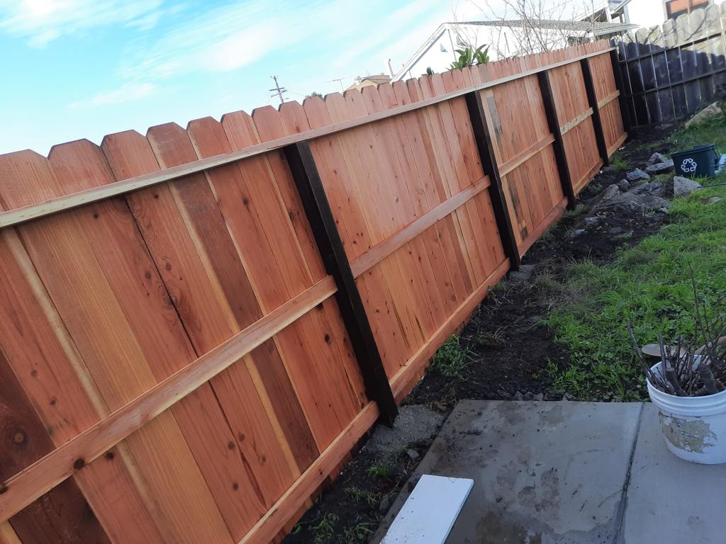 Traditional dog ear redwood fence installation by Hermanos Fence in the Bay Area
