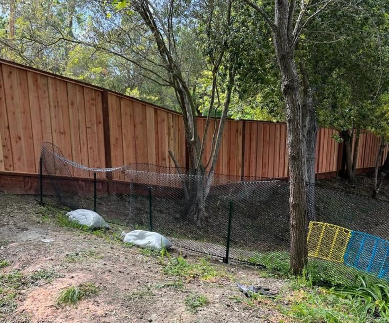 Redwood fence with retaining wall along a higher Fremont yard