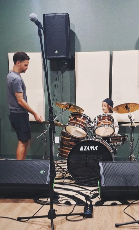 An instructor teaching a drum student at Loud Studios