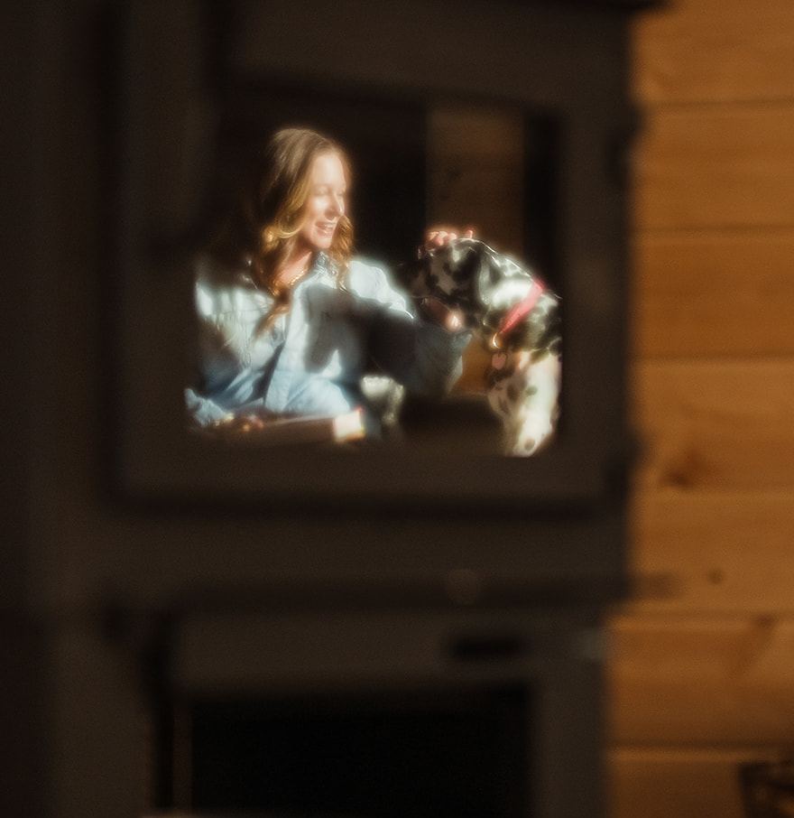 Megan Moore with her Dalmatian, Emma, reflected in a mirror at home