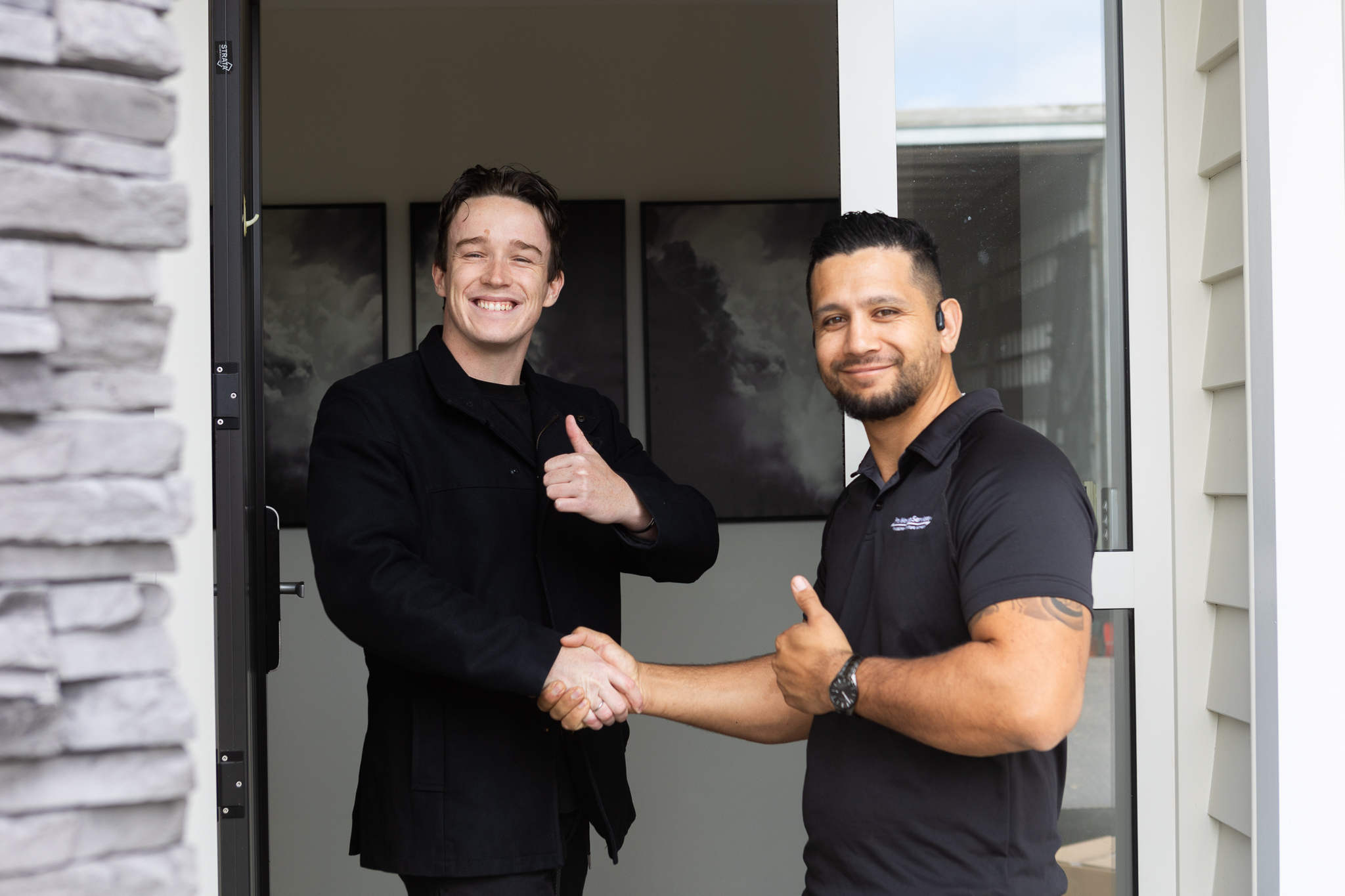 Chair wrapped in plastic film surrounded by moving boxes in a well-lit room, illustrating safe packing and preparation for furniture moving services by Pro Moving.