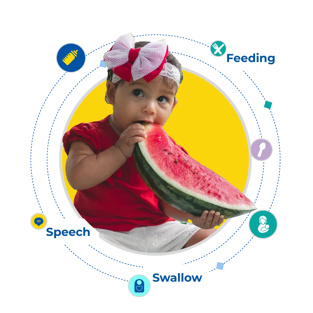 Child at the table exploring food with a therapist