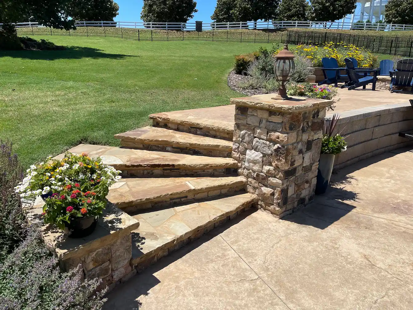 Natural stone steps and stamped concrete patio