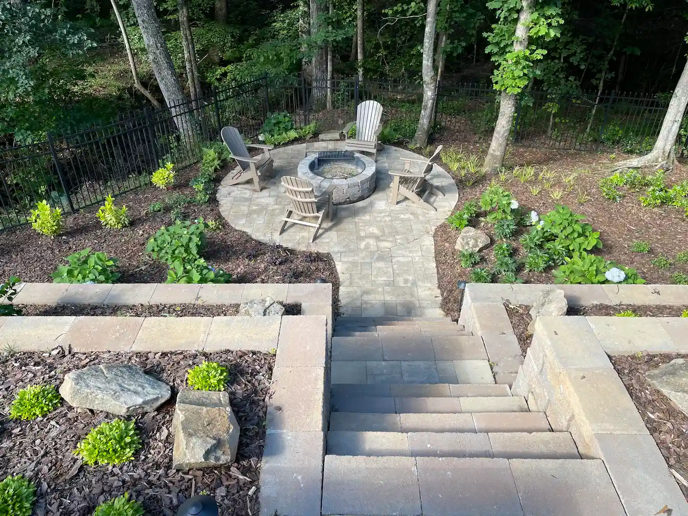 Paver fire pit patio in a wooded backyard