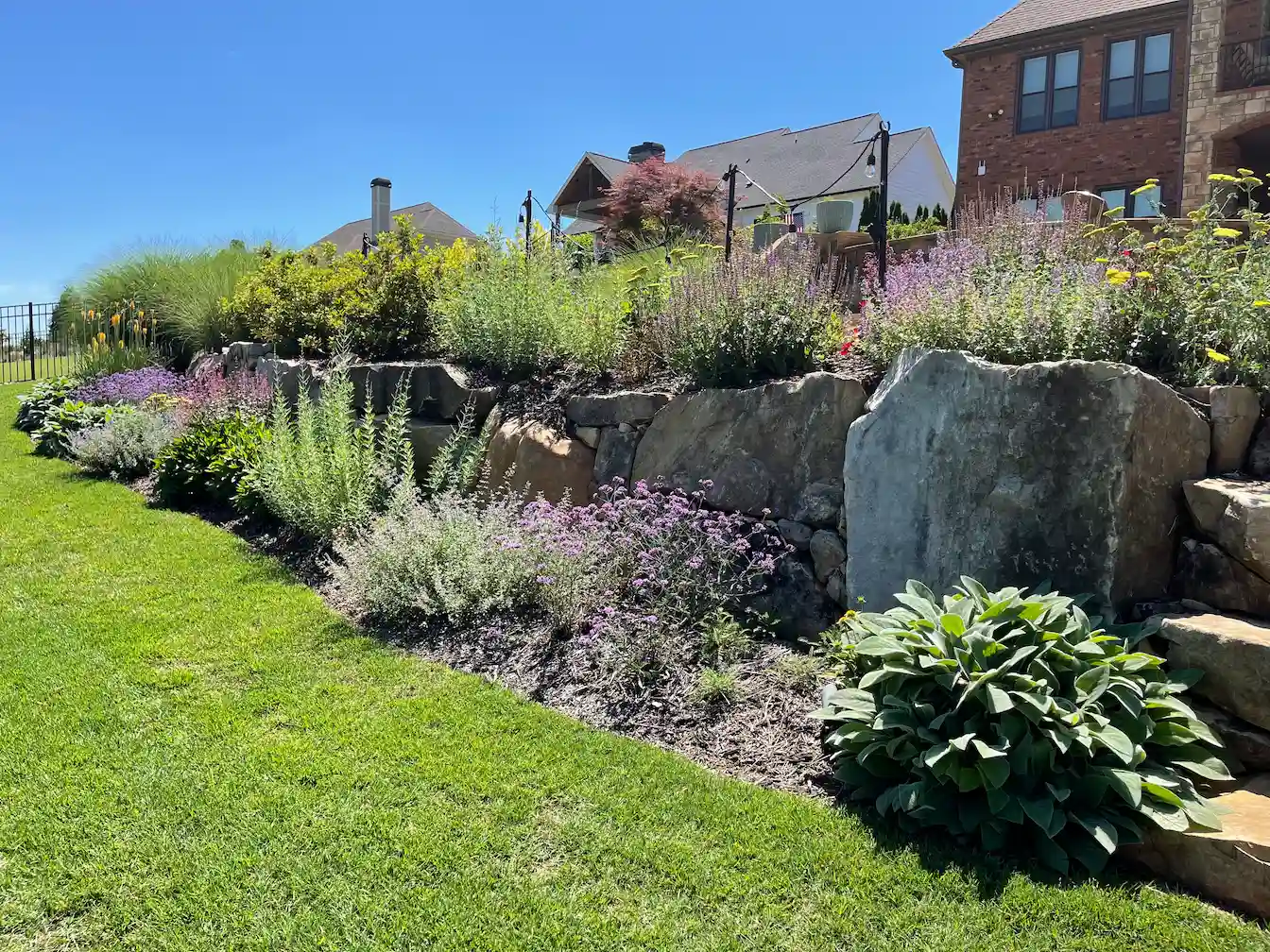Boulder retaining wall and planting beds