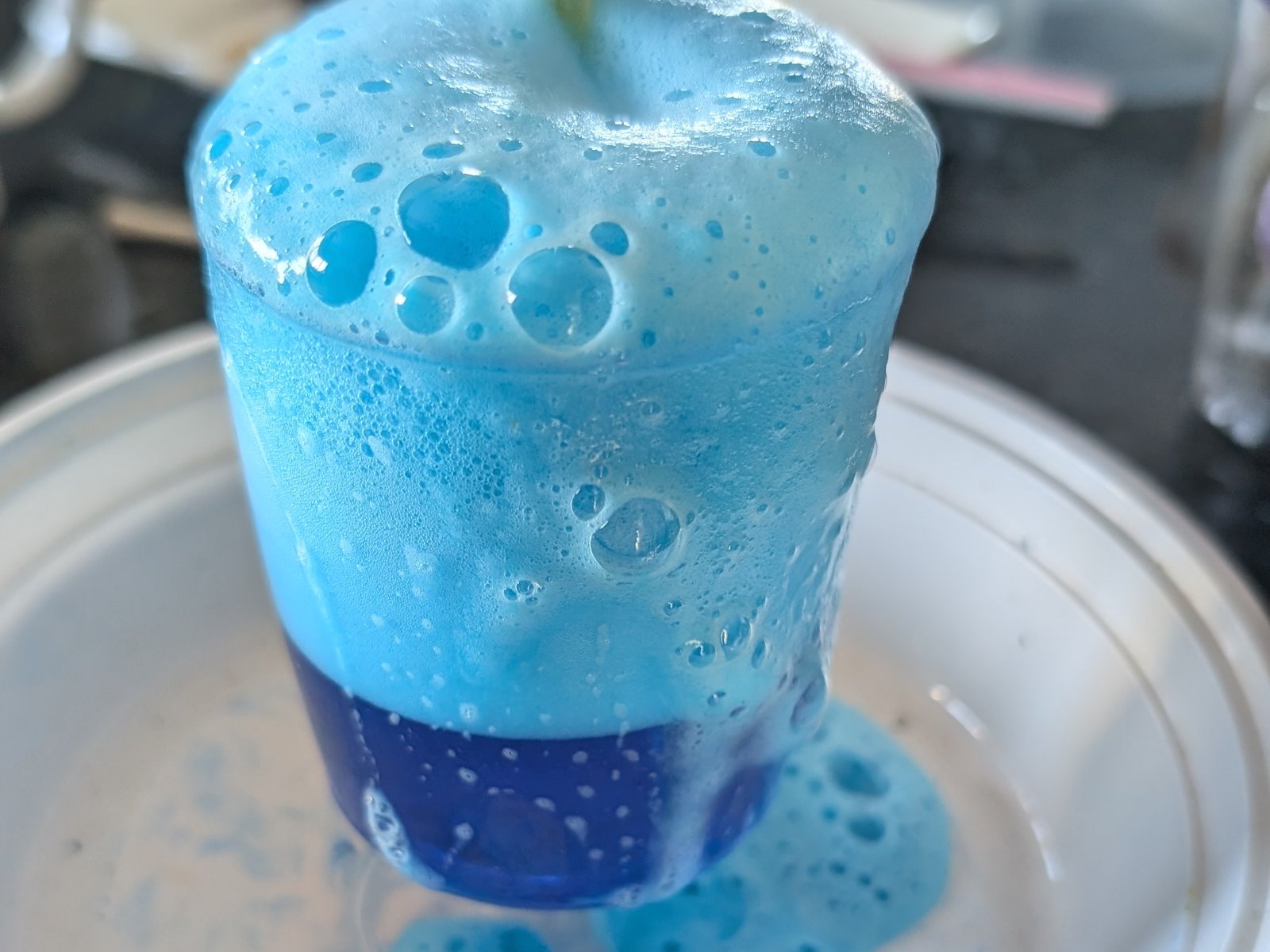 Blue foam erupting from a cup at the Kitchen Science PA Day camp in Burlington.