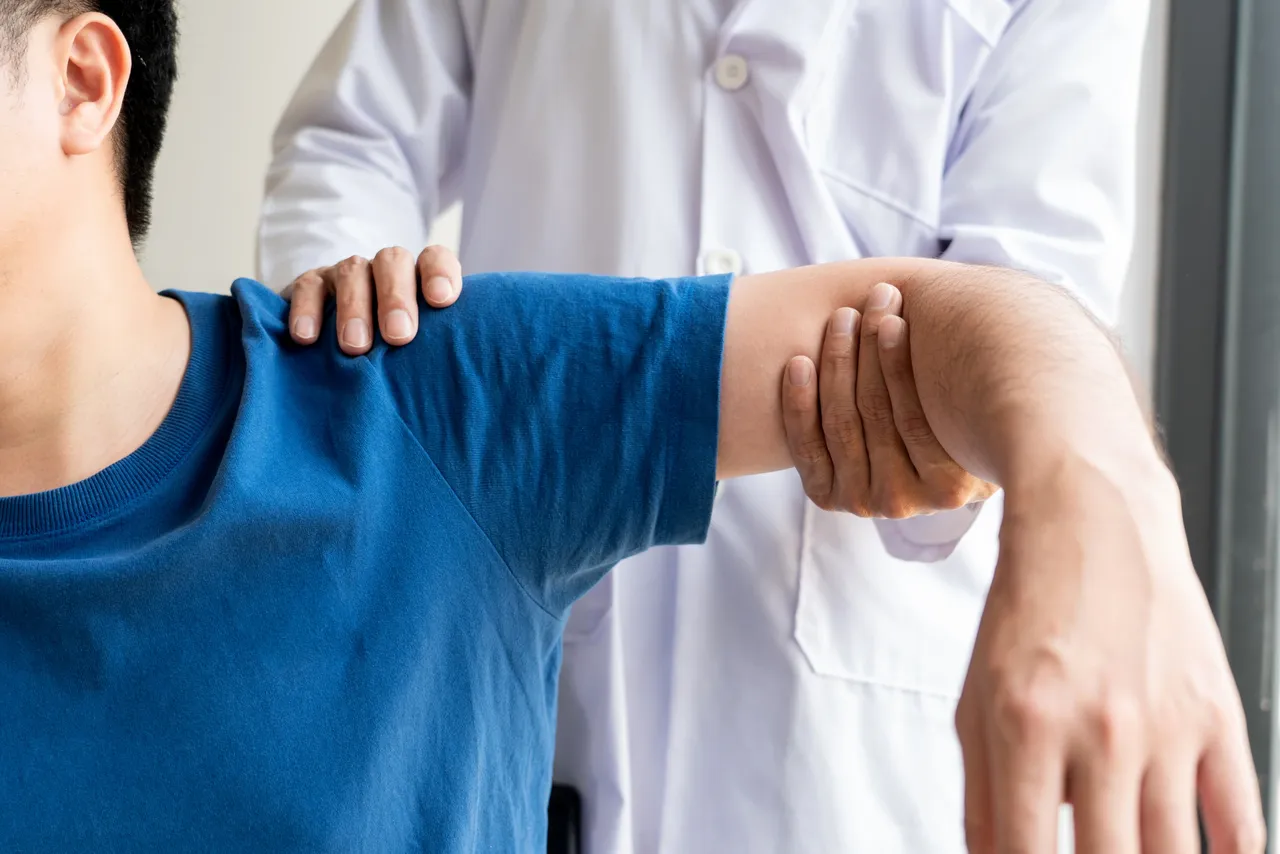 Doctor evaluating patient shoulder mobility