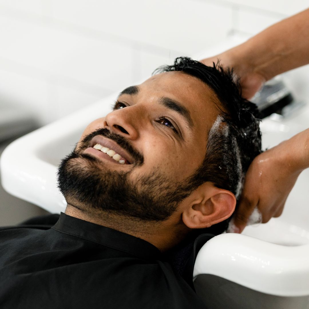 Client enjoying a hair wash service at Salon Salman in Pierrefonds, Montreal