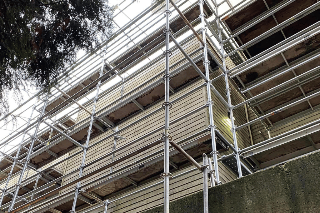 scaffolding set up on a building getting hardie siding installed