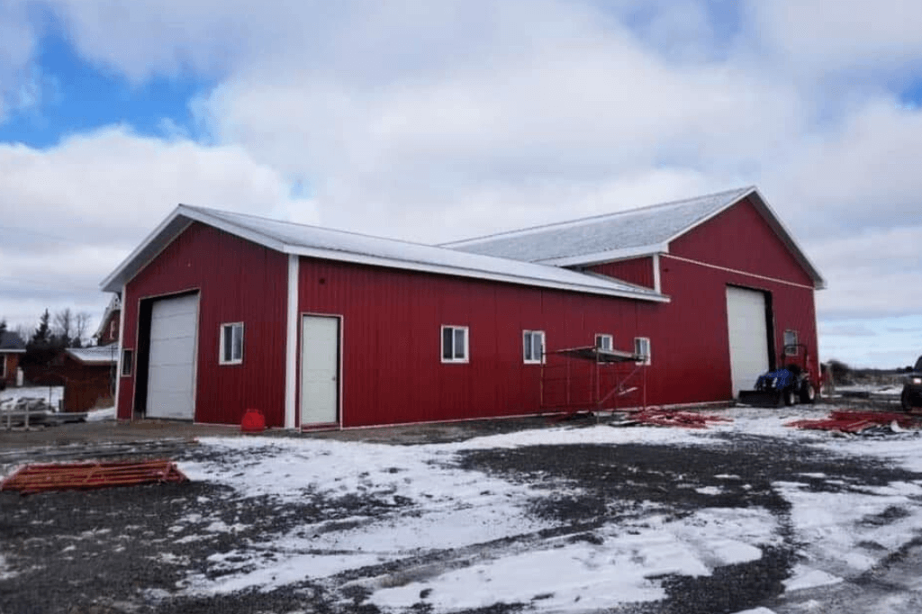 large red shop with metal cladding and a metal roof