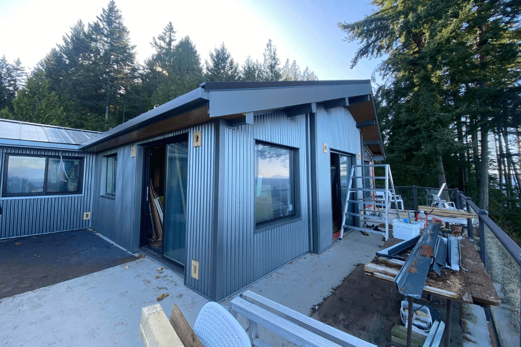 a house with a metal exterior showcasing the custom flashing installation