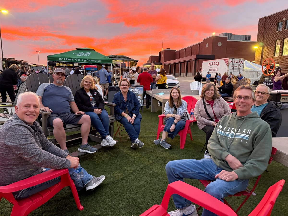 Friends enjoying food at sunset