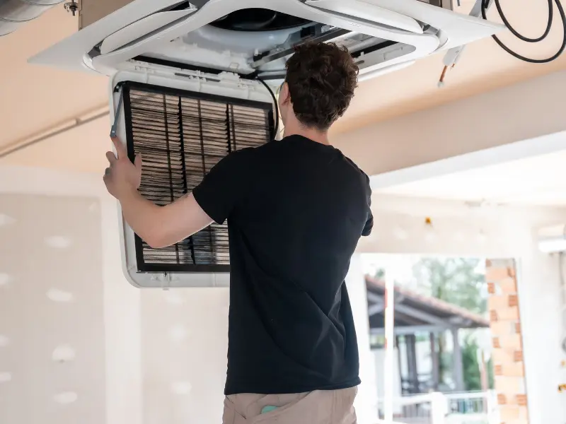 Halcomb Property Inspections inspector assessing a commercial building rooftop HVAC unit in Phoenix AZ