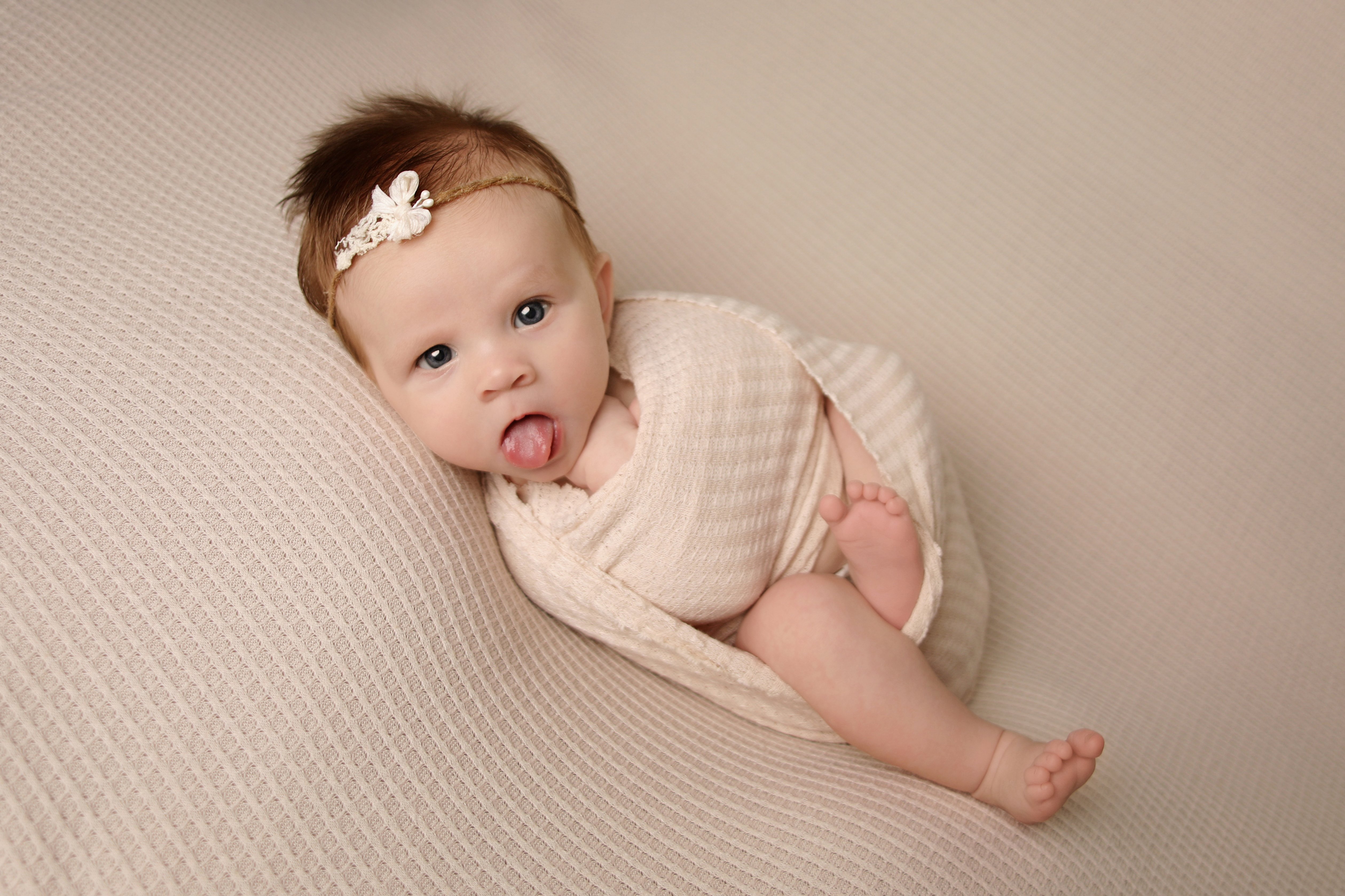 Baby sticking her tongue out - Professional baby photos taken by baby art Manchester