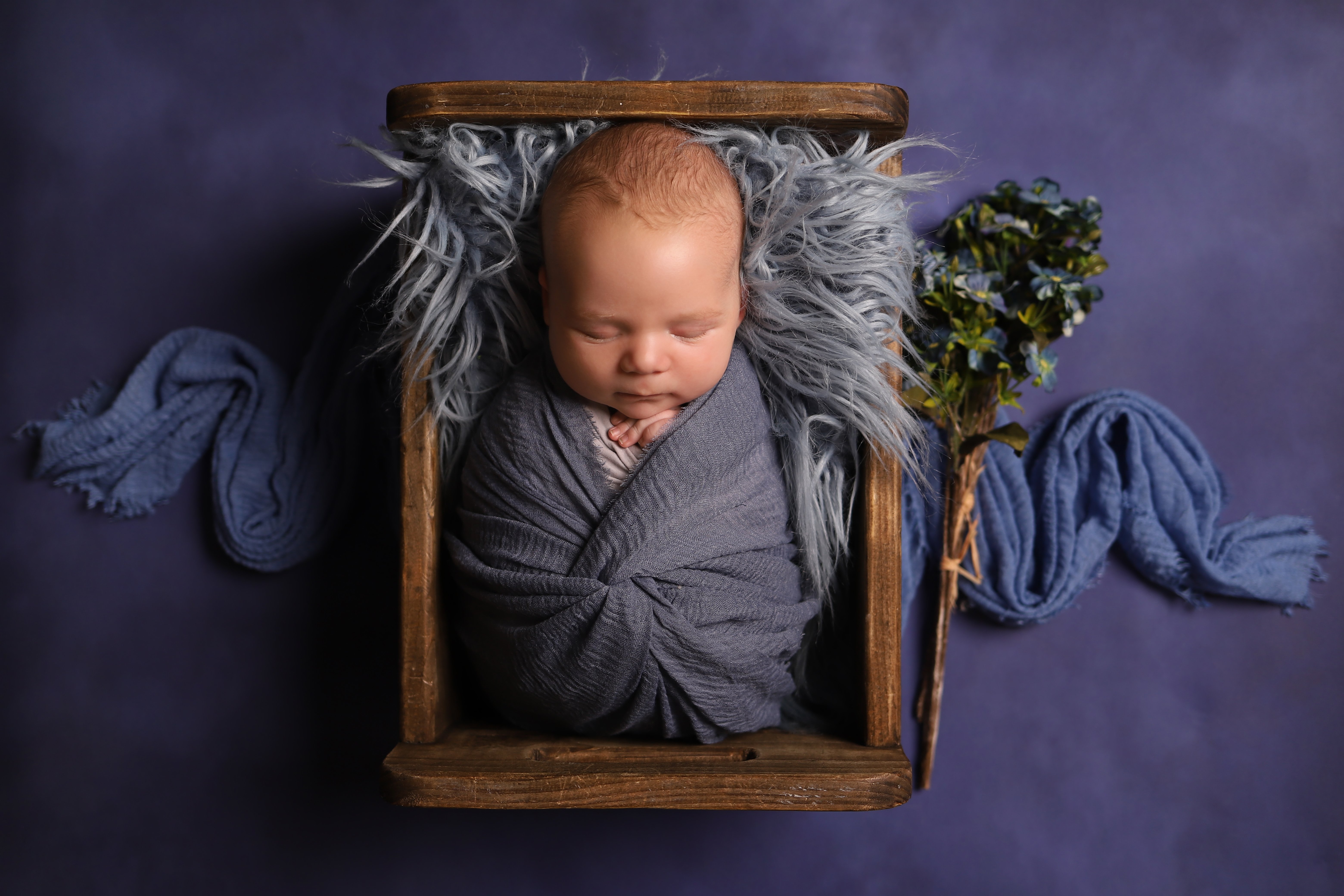 Photo of sleeping baby wrapped up in blankets, taken by professional photographers in Kent