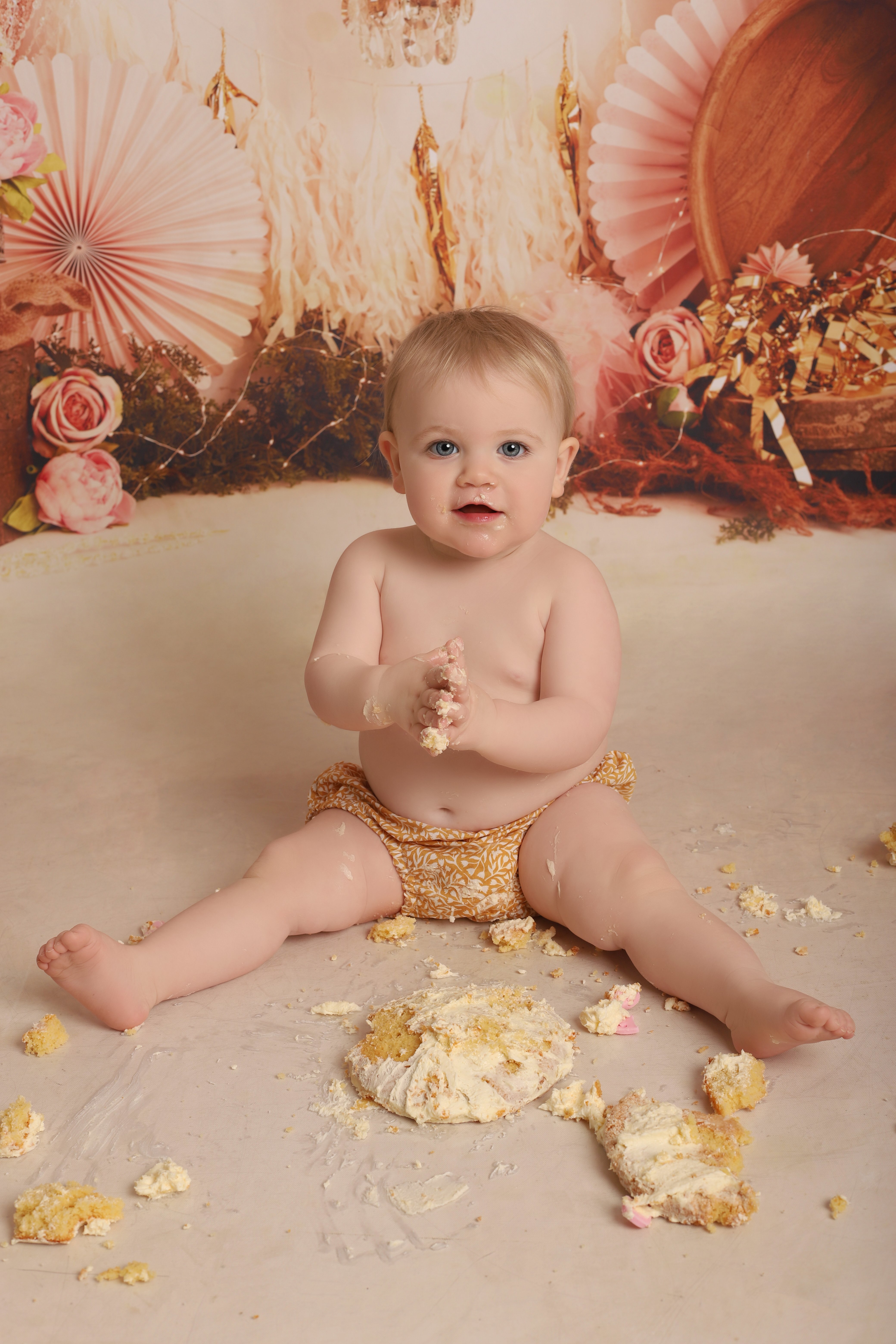 Photo of baby with smashed up cake, taken by professional photographers in Kent