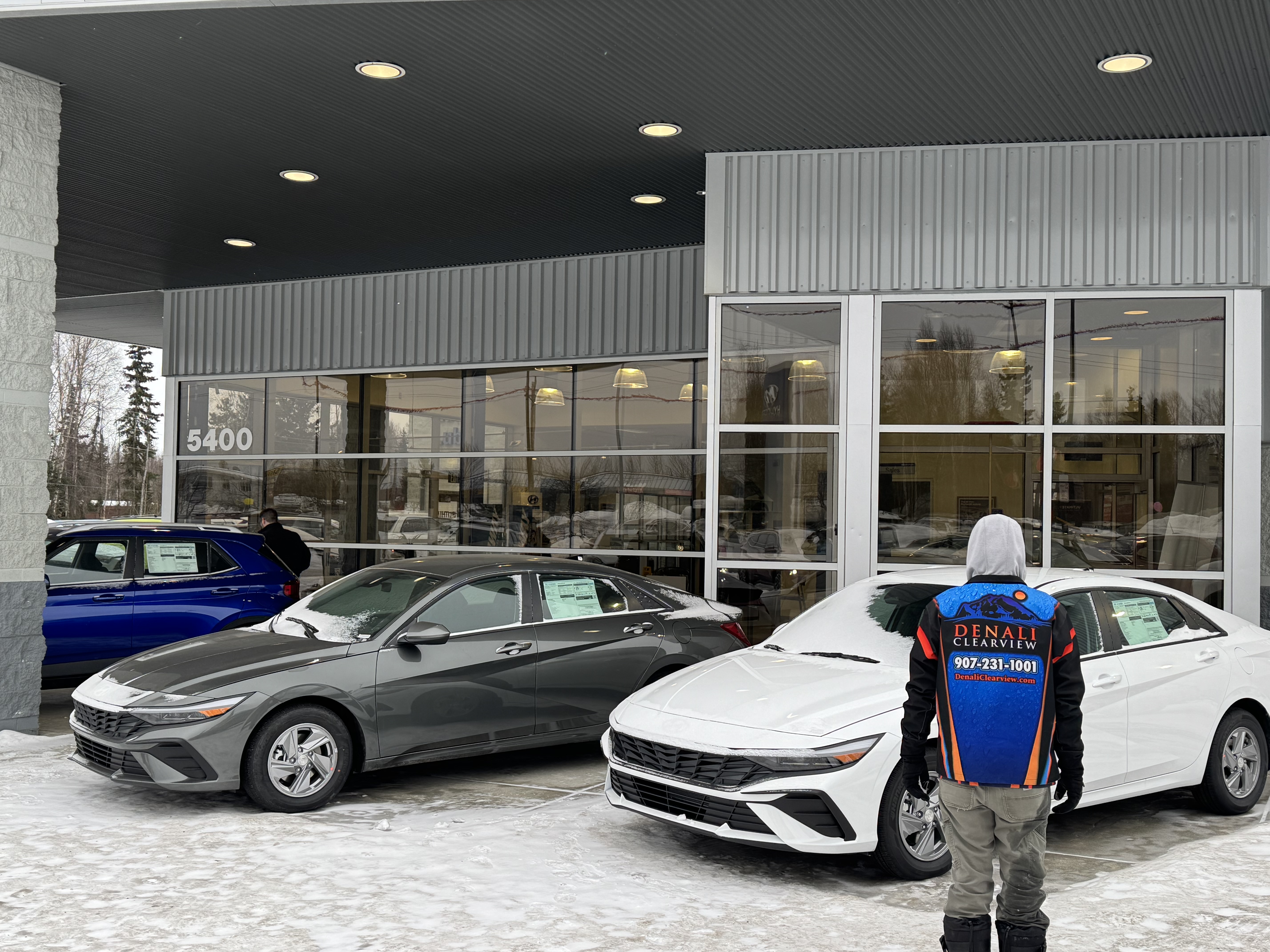 Bright, clean living room with pristine windows looking out at Alaskan landscape