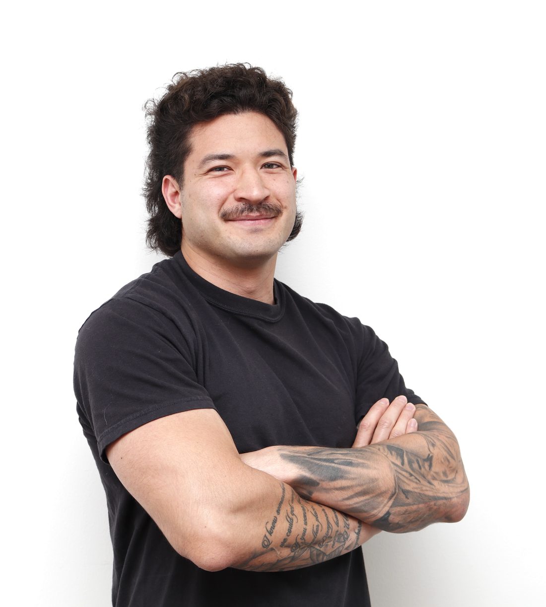 Justin Moy, founder of JD Digital, arms crossed and smiling