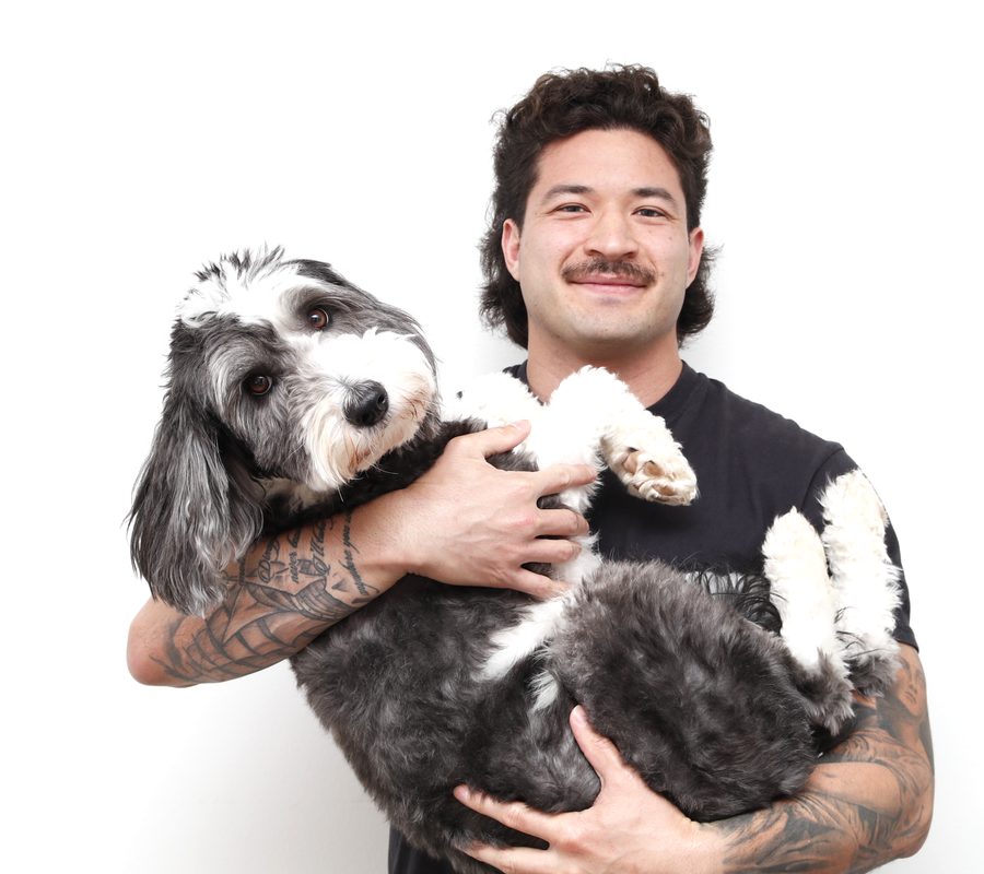 Justin Moy holding his dog