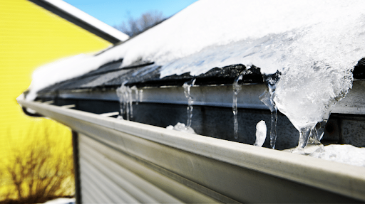 Frozen eavestrough with ice dams forming on a house roof during winter in Ottawa Frozen eavestrough with ice dams forming on a house roof during winter in Ottawa