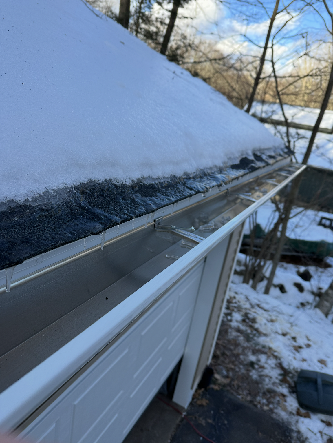 Snow melting off a roof into a clogged eavestrough Snow melting off a roof into a clogged eavestrough
