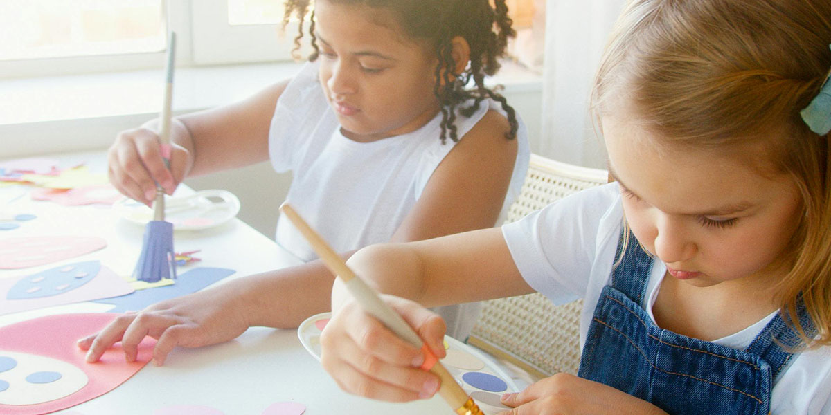 Children painting as part of structured after school care activities