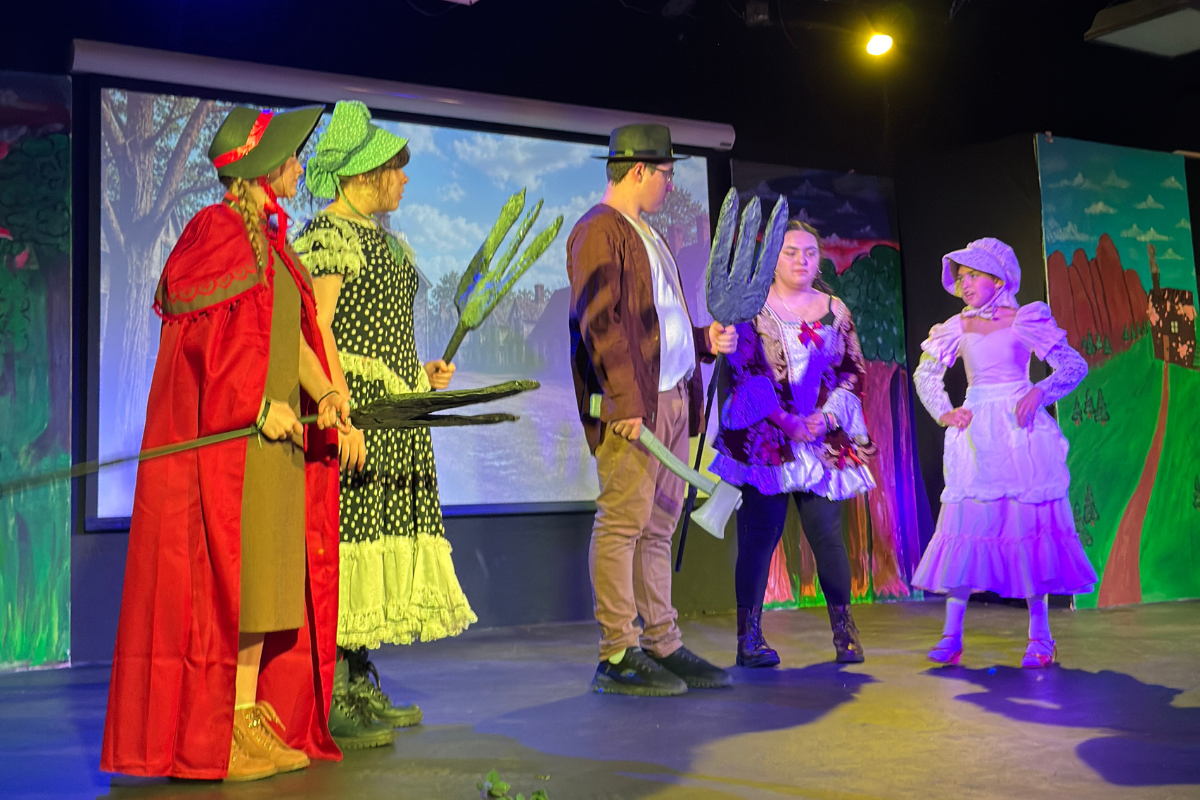 A diverse group of students collaborating on a creative arts project, expressing themselves through visual and performing arts in an inclusive learning environment.